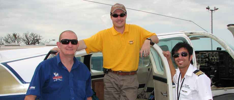 3 people beside plane